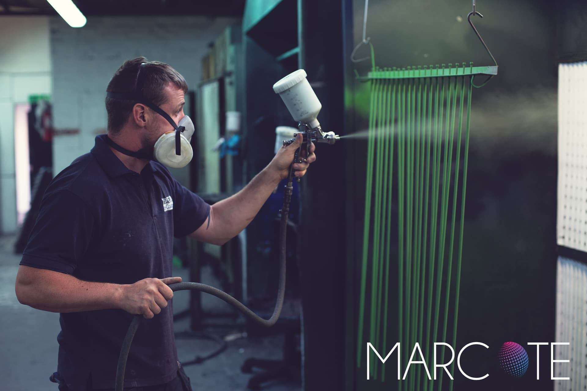 Marcote expert spraying parts with coating