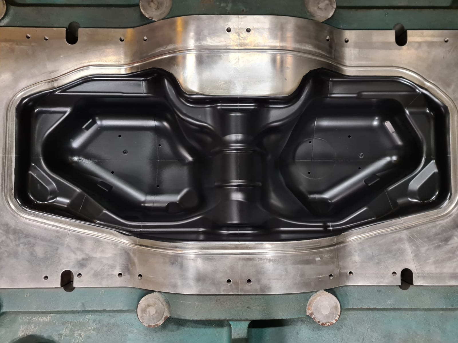 Low friction, black Xylan Coating on a press forming petrol tanks for automotive.