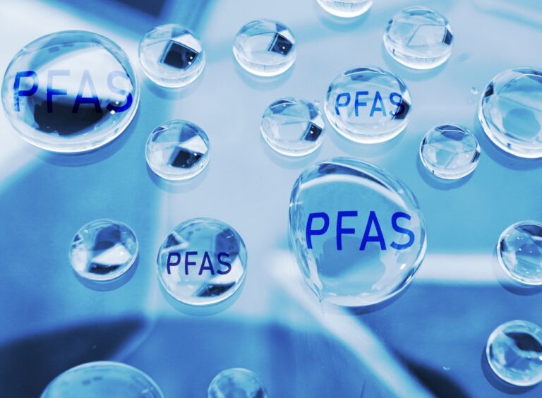 PFAS-Free vs. Fluoropolymer Coatings: Image of water droplets with PFAS text incorporated.
